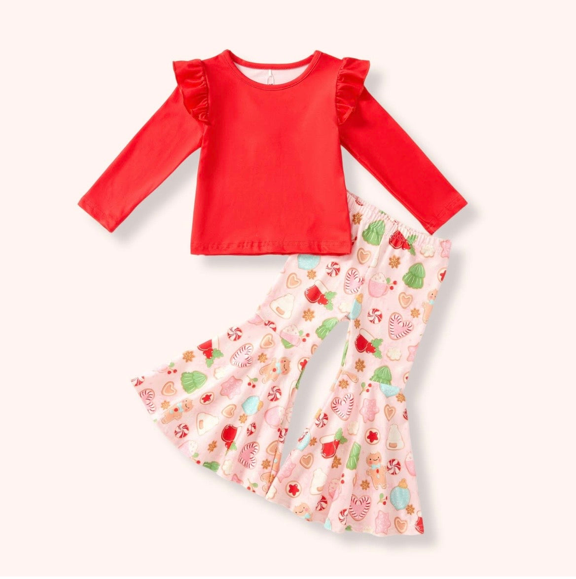Christmas Cookies two-piece pant set with a red long-sleeve ruffle-shoulder top and light pink Christmas treat-print flare pants.